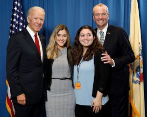 Students posing for a picture with President Biden.